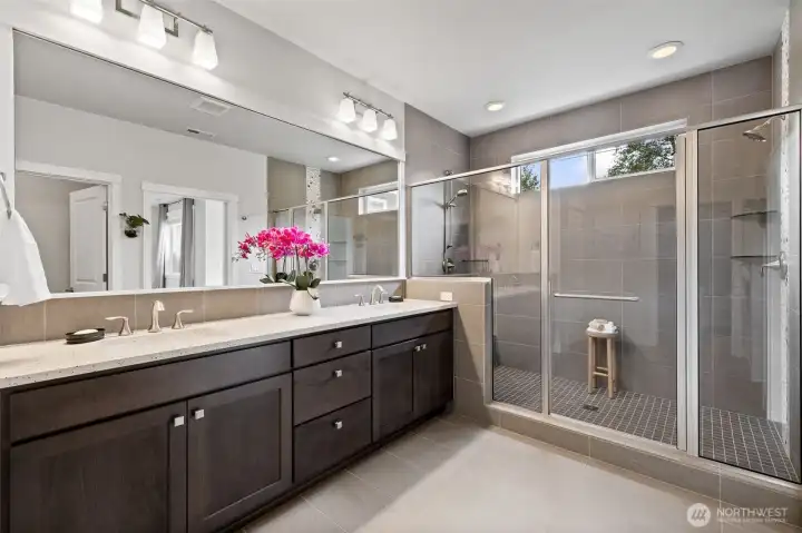 Elegantly designed primary bath leads directly to custom California Closet walk-in combining style and convenience.