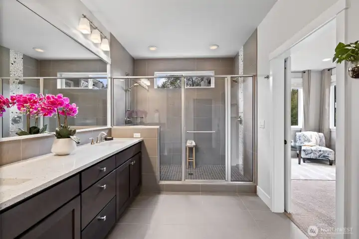 Elegantly designed primary bath leads directly to custom California Closet walk-in combining style and convenience.