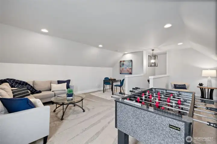 Private bonus/game room, above garage, offering flexible space for entertainment, play, or guest accommodations.