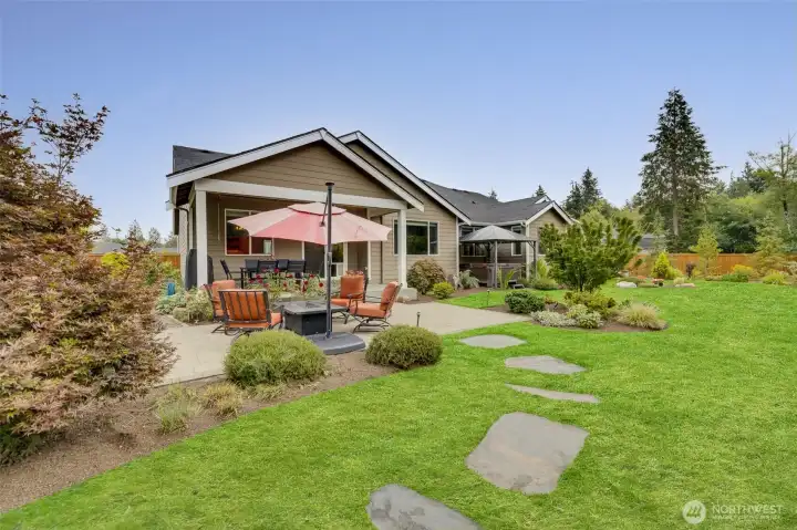 Covered and heated outdoor sitting area, plus adjacent fire pit table/seating offers a truly beautiful and tranquil retreat year-round.