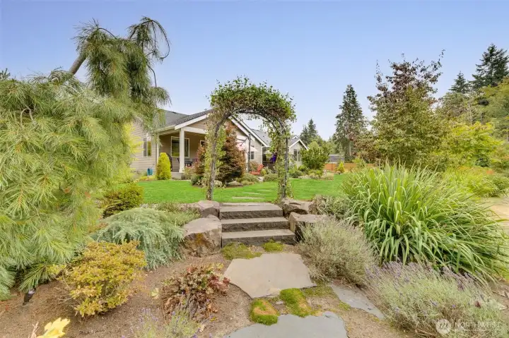 Beautiful archway leading from back patio to fire pit.