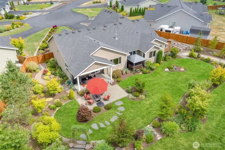 Lush lawn and professional landscaping enhance the beauty of this immaculate, park-like 1+ acre oasis.