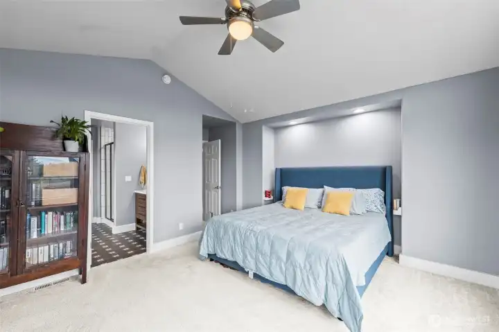 Vaulted Ceilings in the spacious Primary suite seamlessly flows into the ensuite spa-like bathroom.