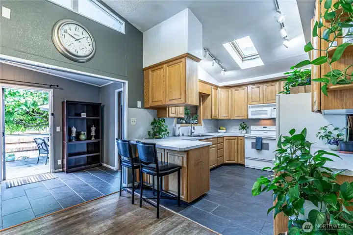 Kitchen has vaulted ceilings and skylights.