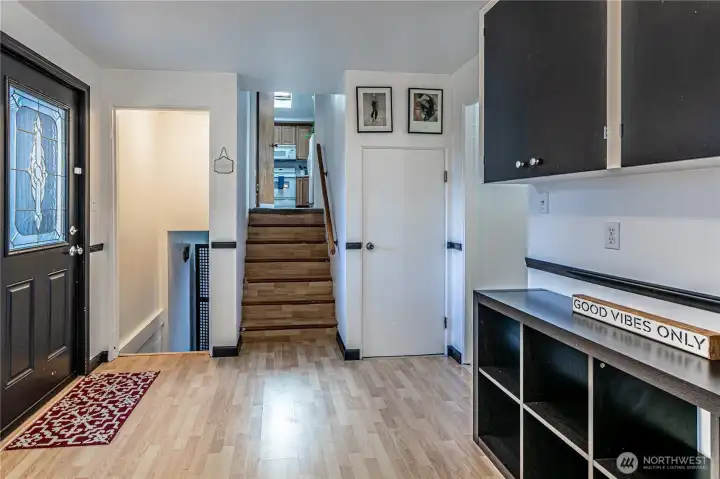 Landing area to studio, half bath and lower level bedroom.