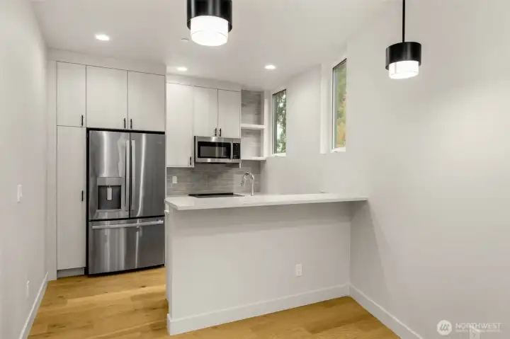 Kitchen features stainless steel appliances, quartz countertops & breakfast nook!