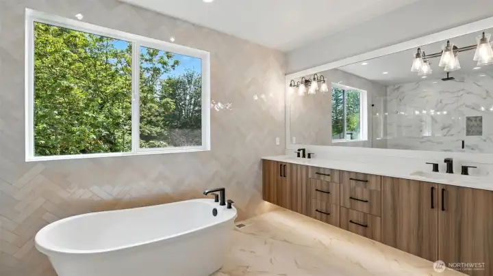 Sumptuous Primary 5-Piece Bath, featuring heated tile floor, floating double-sink vanity, soaking tub and rain head shower.