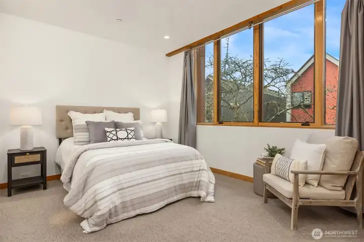A second bedroom with ensuite bathroom and west-facing windows