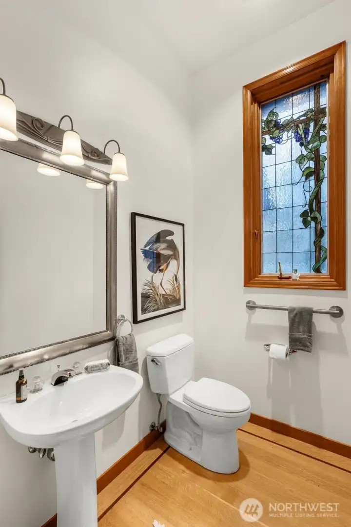 Half bath has a beautiful custom stained-glass window