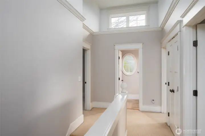 Bright and light upstairs hallway with lots of natural light! Laundry is stackable off to the right in the closet.