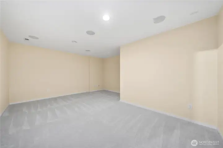 Lower level bonus room, originally set as home theater with surround sound wired in ceiling.