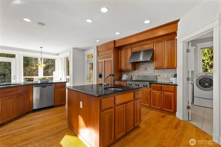 Gourmet kitchen complete with 6-burner gas range, double ovens, walk-in pantry, and a breakfast bar.