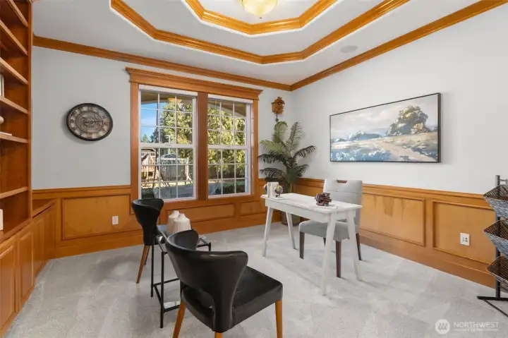 Main floor den perfect for an office with grand built-in shelves right across the primary bedroom.