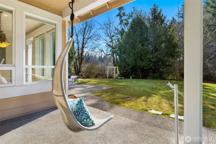 Back covered patio overlooking the private, wooded backyard.