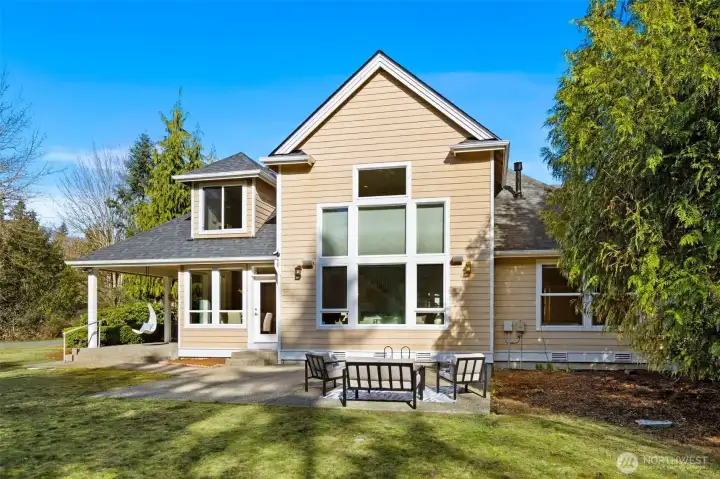 Covered back porch with an expansive concrete patio.