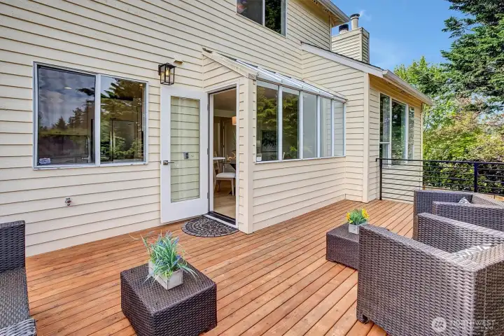 Bright and sunny deck that is directly accessible from the main floor kitchen, offering a seamless indoor-outdoor living experience.