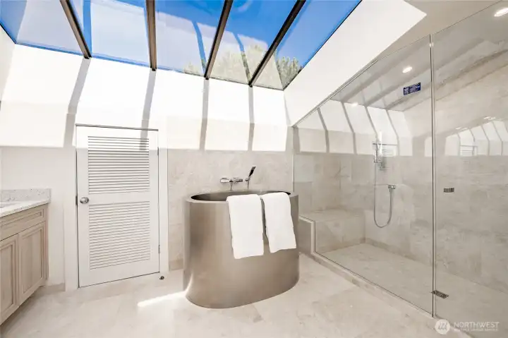 Japanese soaker tub in ensure bath room and huge skylights
