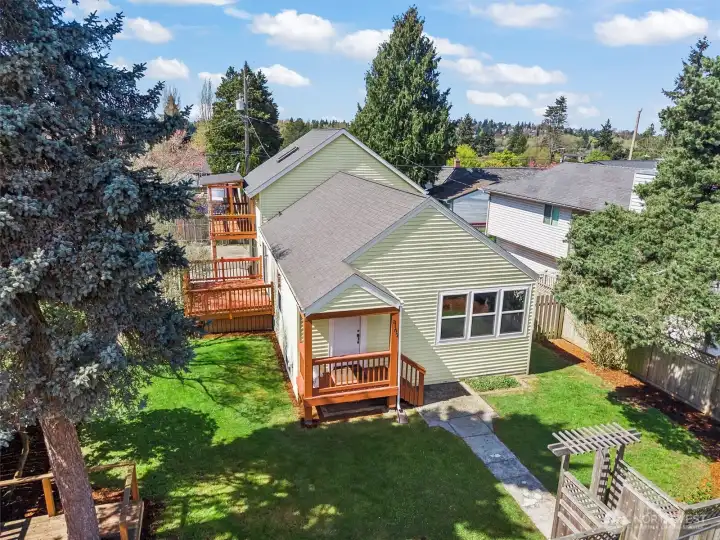 Inviting front porch, enjoy meals on the deck off the dining room, or relax on the private primary suite deck