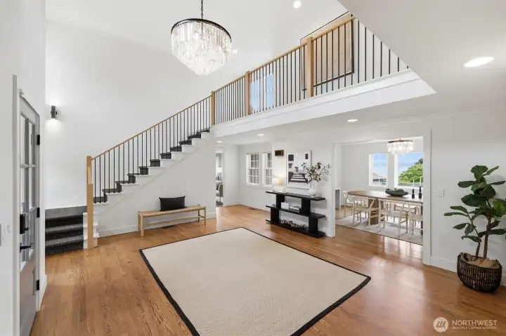 Notice the handsome hardwood floors and the expansive foyer and chandelier.