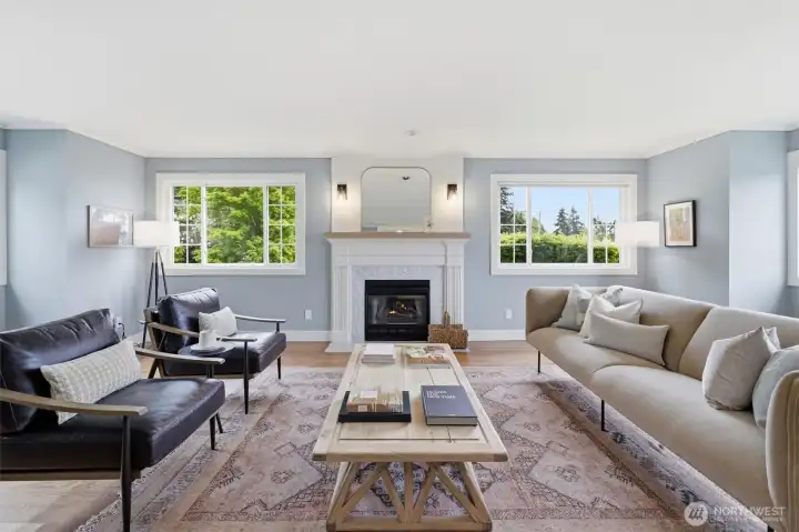 The formal living room is sited off the foyer. The focal point is the wood-burning fireplace and wood wrapped windows.