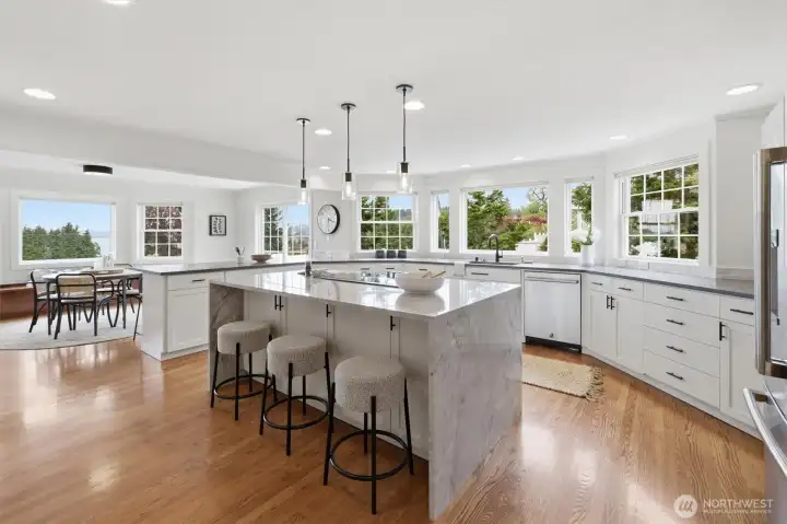 Refreshed in 2023, the kitchen is a well-appointed luxurious space! Notice the large island and extensive cabinet space.