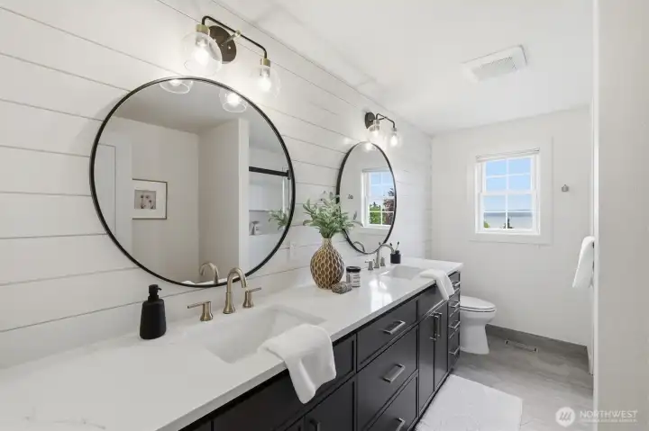 This refreshed full bath complements the bedrooms on the upper level. The dual sinks are a nice touch.