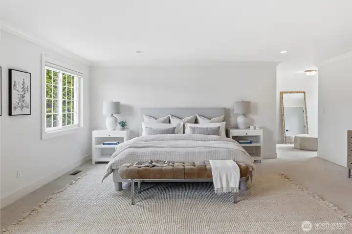 A view of the primary bedroom looking towards the changing area (a great reading nook) and the walk-in closet.