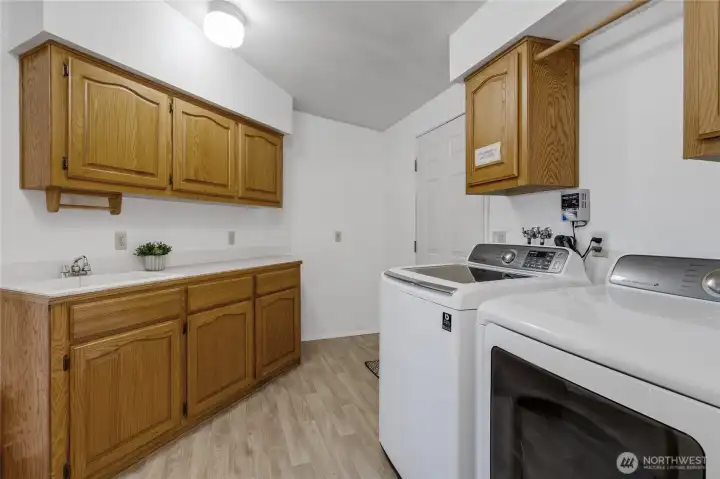 Laundry with back deck and yard access. W/D included with sale