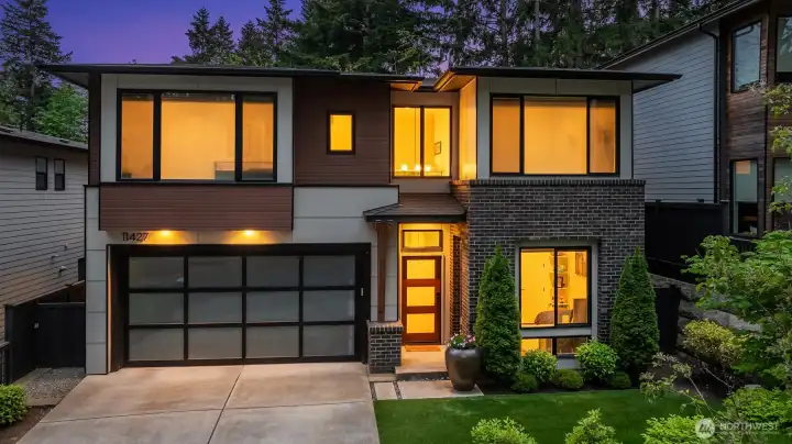 Front elevation at golden hour, with integrated garage and covered entry