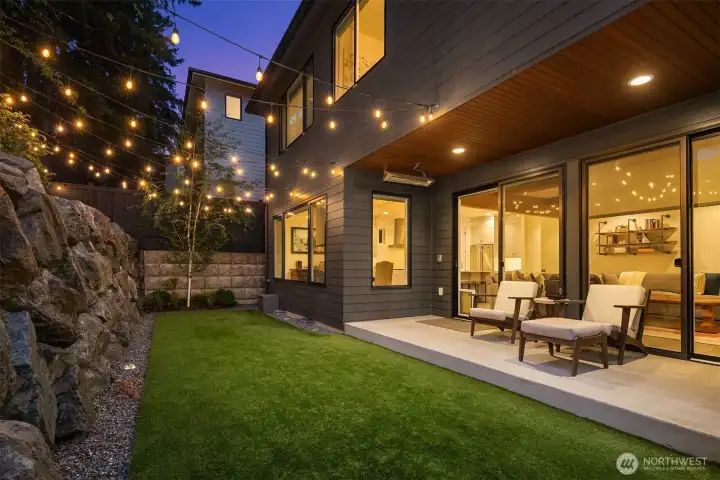 Backyard ready for summer evenings under string-lit canopy