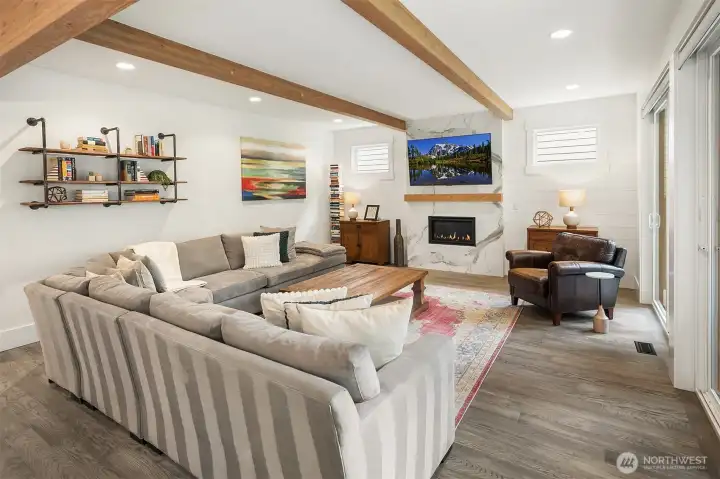 Open-concept living with cathedral beam ceilings and natural light