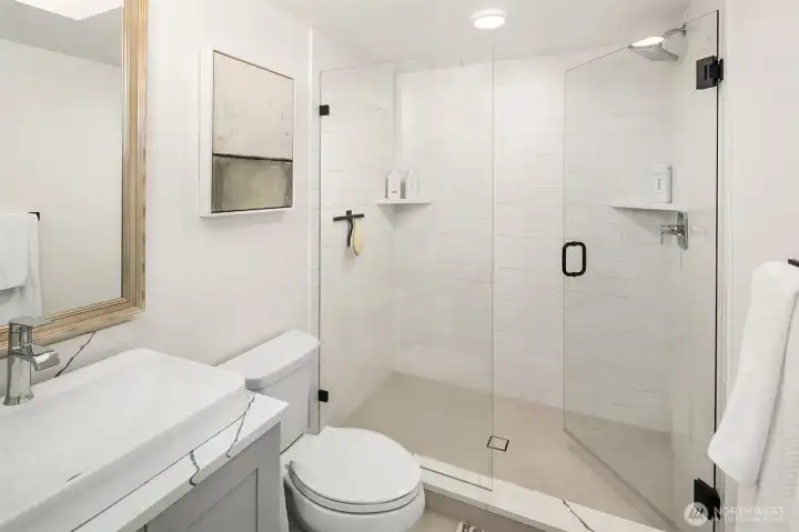 Three-quarter bath with walk-in shower and full-height tile