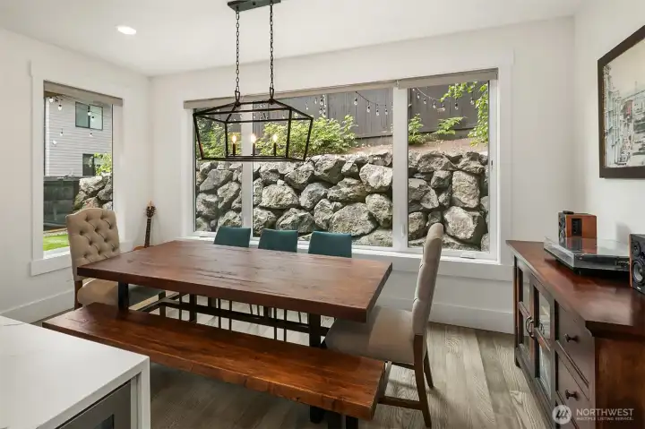 Formal dining beneath a custom industrial fixture
