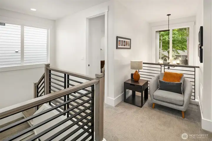 Modern stair landing with steel railing and natural light