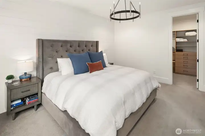 Owner's suite with custom paneled accent wall