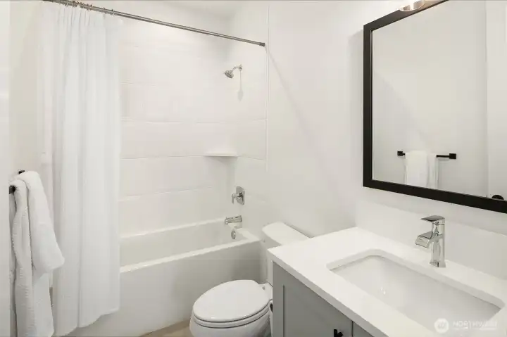 Three-piece bathroom with tub-shower combination