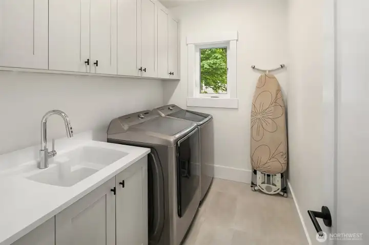 Laundry room with full-size machines and folding counter