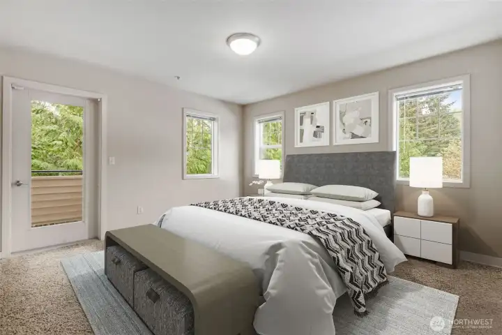 Spacious primary bedroom with double closet for practical storage and private door to balcony. *This photo is virtually staged.