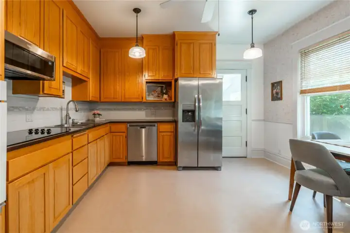 Kitchen with eco-friendly Marmoleum flooring. Back door leads to large laundry/mudroom with half bath