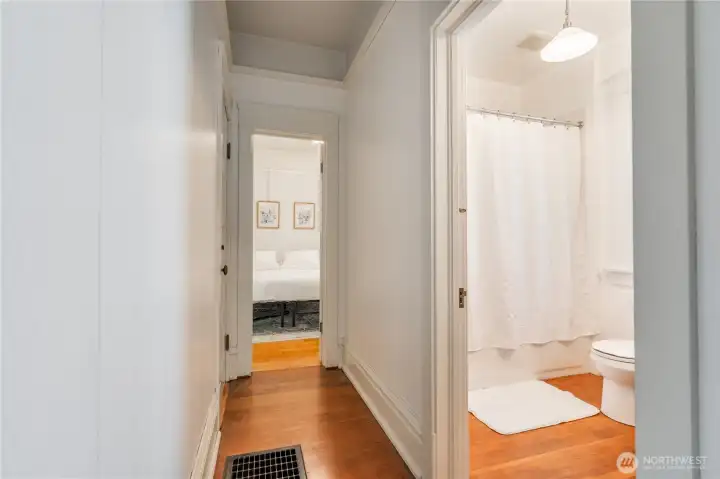 hallway with access to bathroom, bedroom, kitchen, and basement