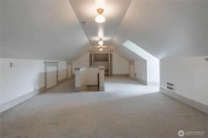 spacious attic with newer carpet. Ideal for bedroom, office, retreat, play room, work out area.