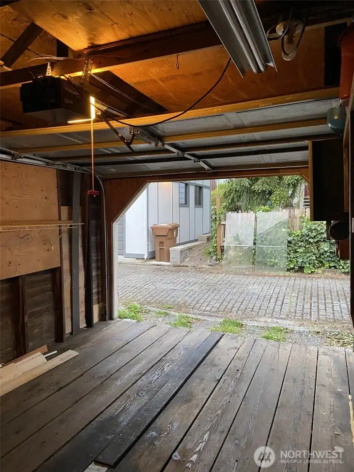 View from garage to well maintained alley access. Owners fit midsize vehicle inside when not used for storing boxes to move.