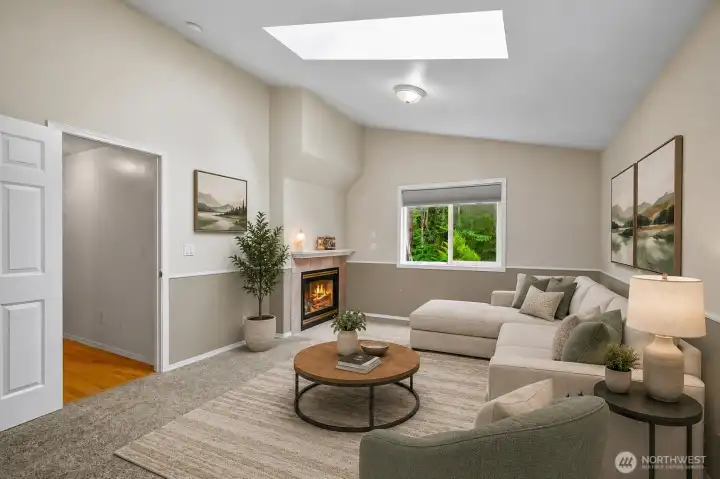 Main floor bonus room with vaulted ceiling, skylights & 2 sided fireplace.