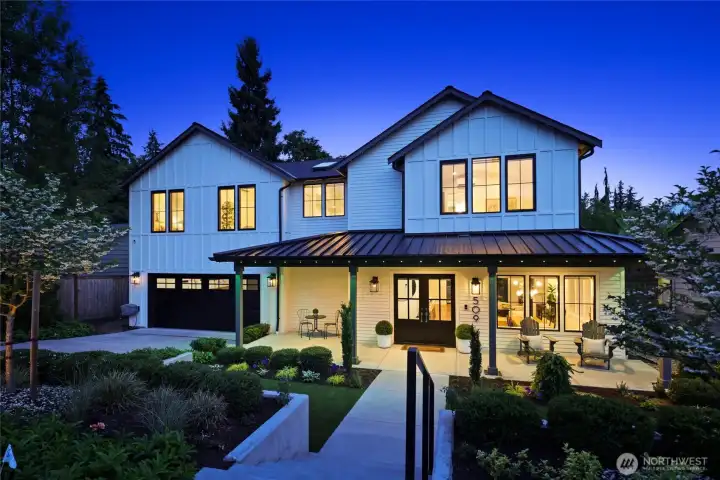 Beautiful twilight curb appeal on this luxury farmhouse