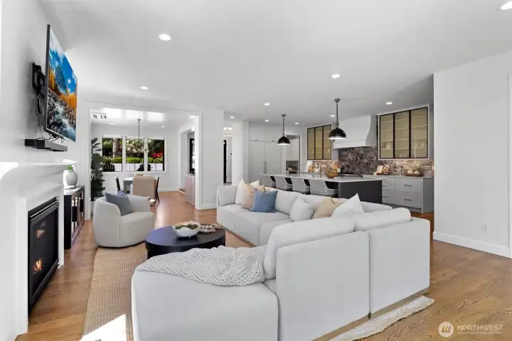 Main open-concept living space with seamless flow to Kitchen, Dining & Outdoor entertaining patio through Fleetwood sliding doors. Gas Fireplace. TV conveys with home.