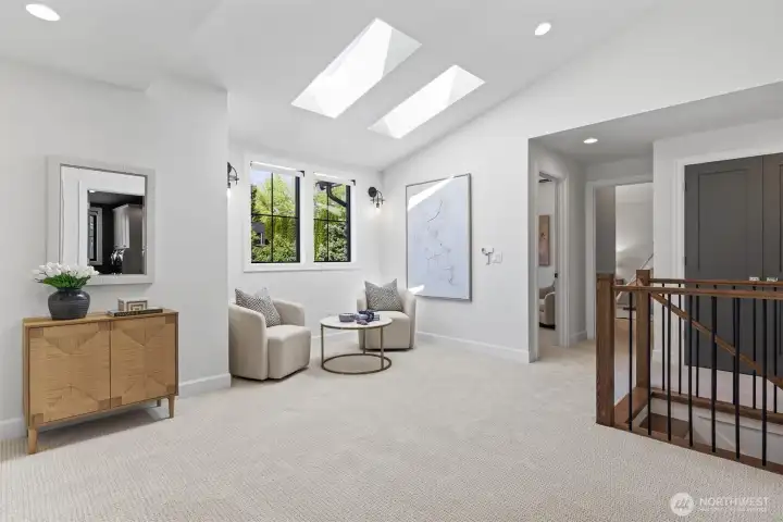 Upstairs loft space with skylights creating a communal space between multiple bedrooms upstairs