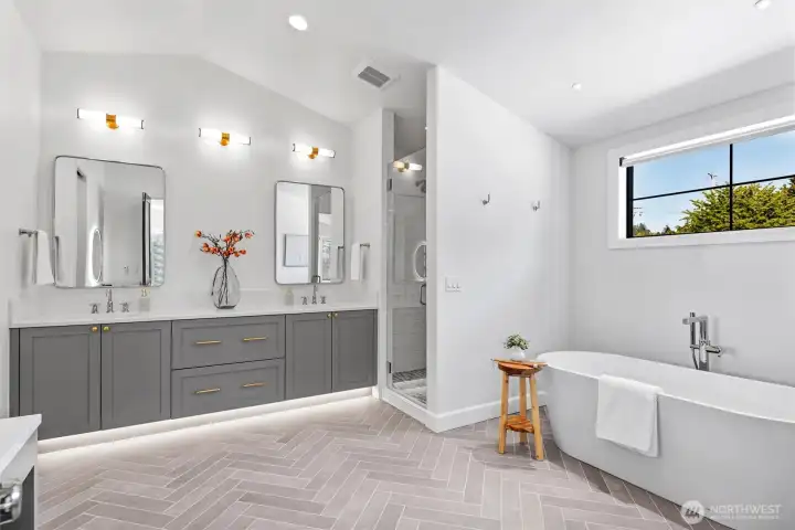 Spa inspired 5-piece primary ensuite with heated floors, soaking tub, dual shower heads, and dedicated vanity space (not pictured)