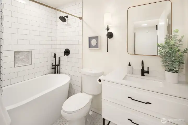Updated guest bath with newer vanity, tub, tile shower and tile floor Updated guest bath with newer vanity, tub, tile shower and tile floor