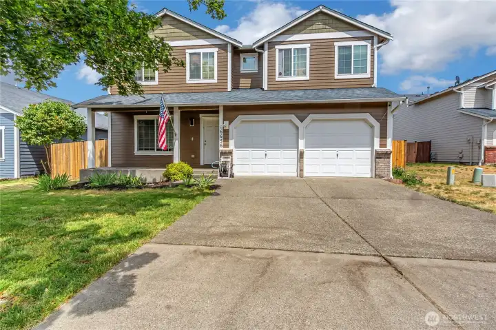 There is space between the homes, a lovely front porch and lots of space for parking