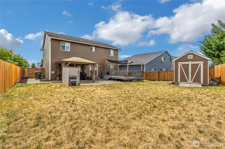 Nice side patio with a generous side yard. Second out building on patio by gazebo